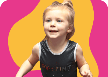 Bright smiling young girl with blonde hair in a ponytail, wearing a black sports top, energetic and cheerful, enjoying a fun activity.