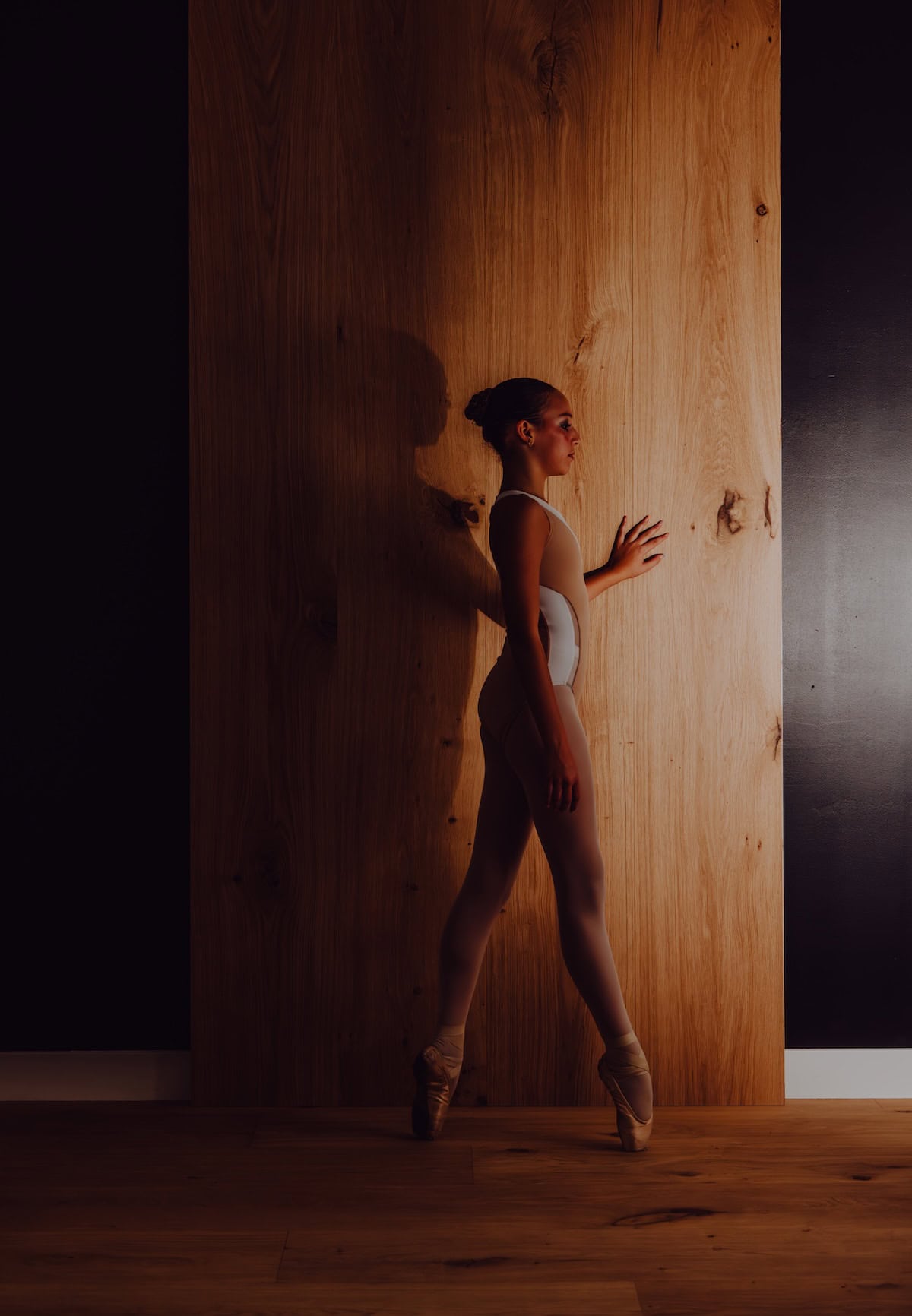 Dancer on pointe in front of wide plank european engineered hardwood flooring plank