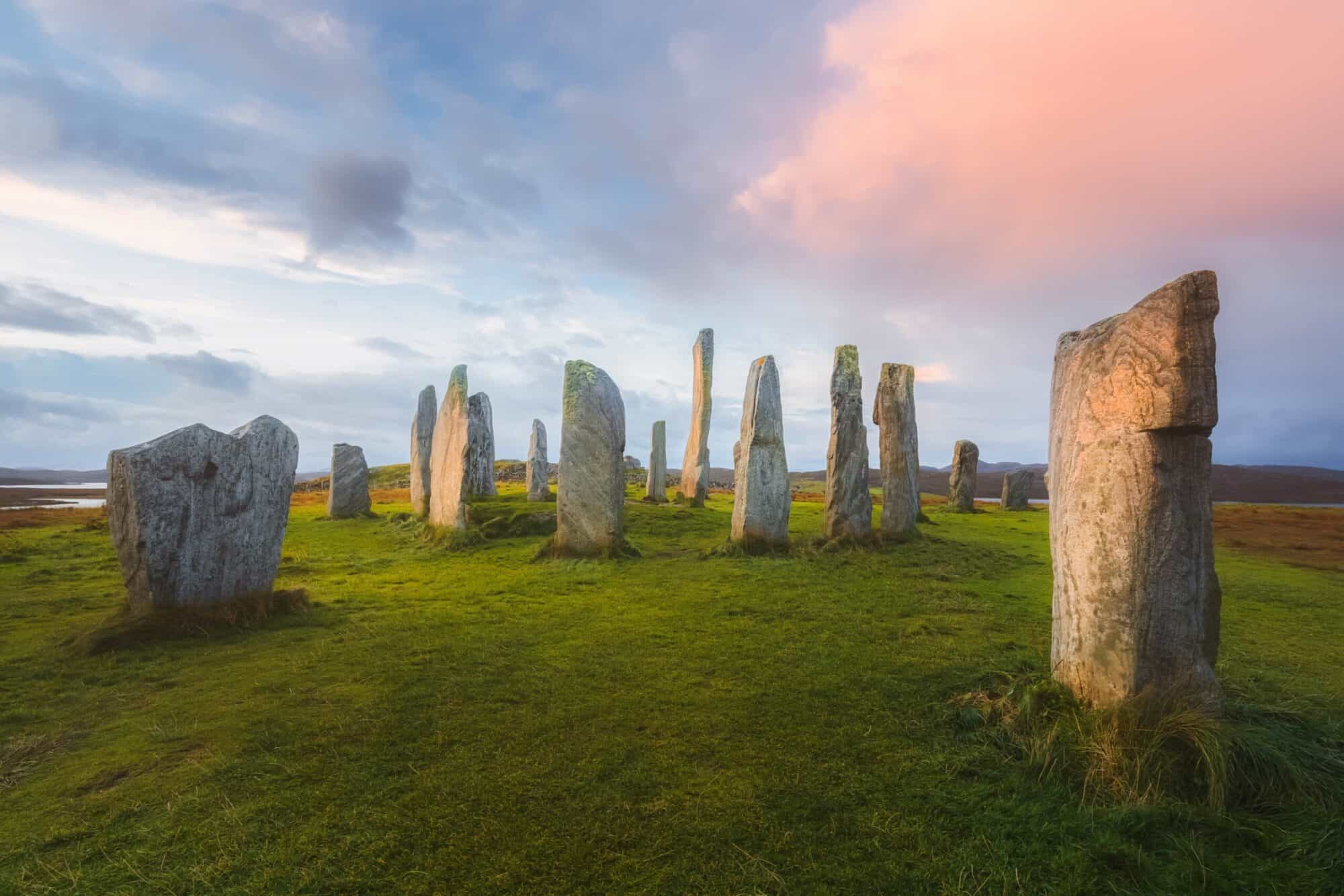 Stones of Stenness, archaeological site, Hebrides, Scotland with sunset sky, scenic outdoor landscape.