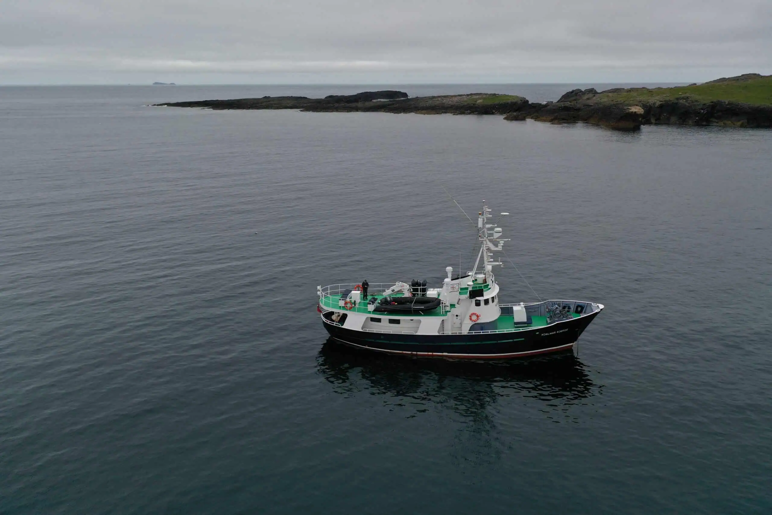 A Hebridean Adventures boat cruising around scenic Scottish islands showcasing whale watching and marine wildlife tours.