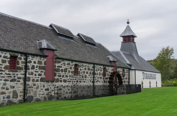 Charming traditional stone church on Hebridean island with lush green surroundings, perfect for island adventures.