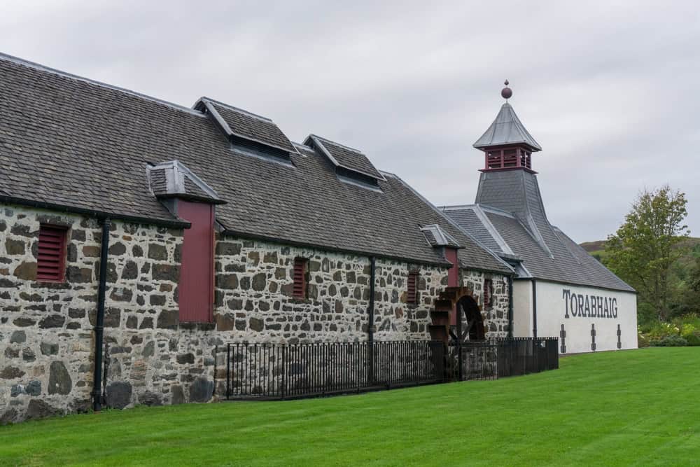 Charming traditional stone church on Hebridean island with lush green surroundings, perfect for island adventures.