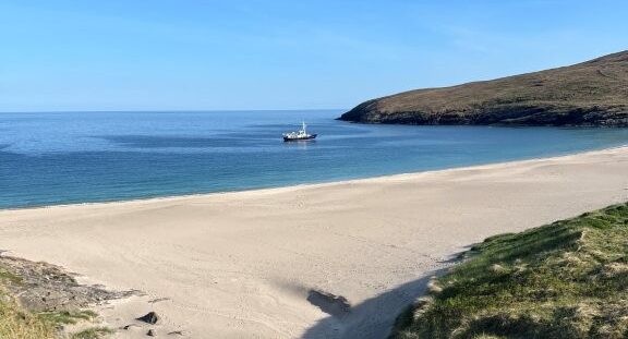 Mingulay with the Hjalmar Bjorge in the background