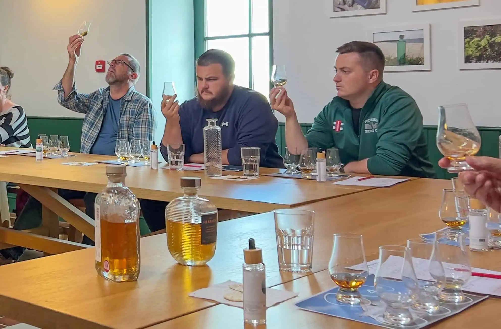 A group of people tasting whisky during a guided whisky tasting experience in the Hebrides.
