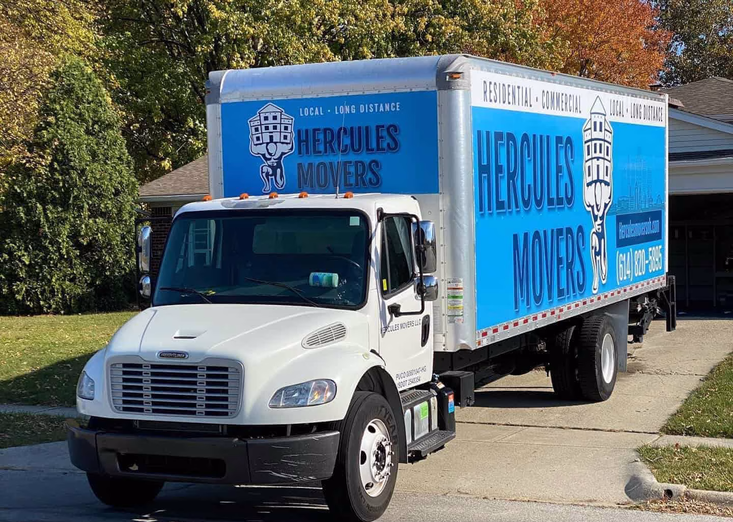 Hercules Movers truck parked on residential street.