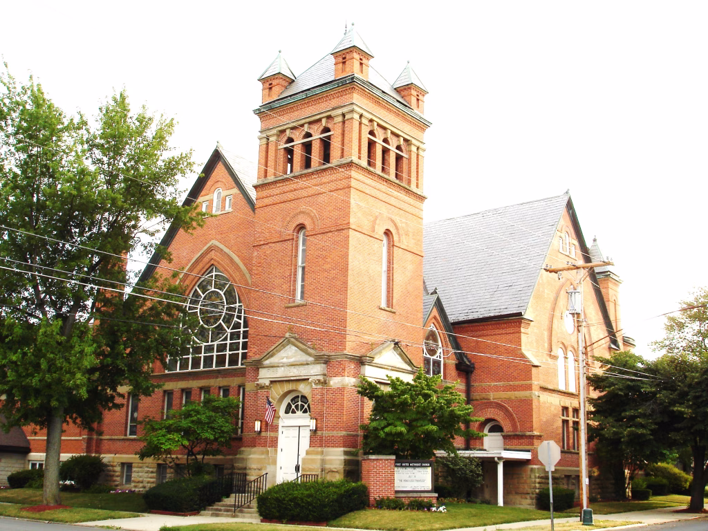 Historic red brick church with large arched windows