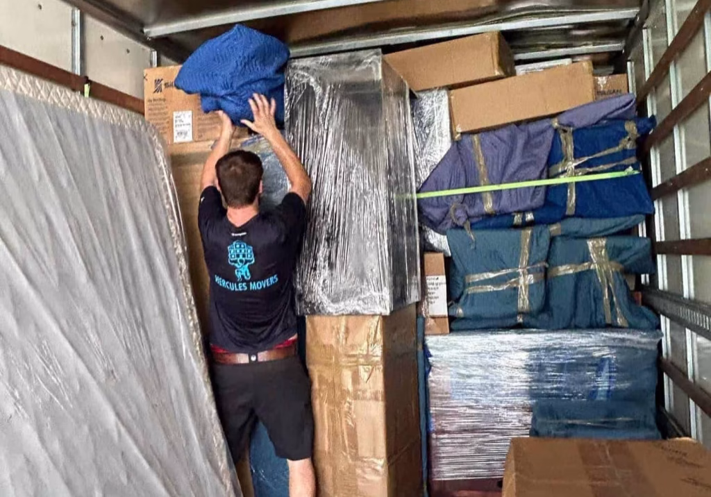 Person organizing boxes in moving truck