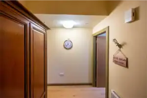 Interior view of Highland Club Scotland entrance hall with wooden wardrobe and wall decor.