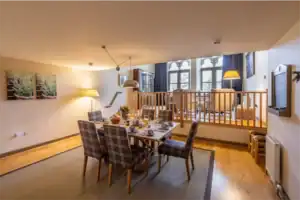 Elegant Highland Club apartment with a cozy dining space and a raised sleeping area.