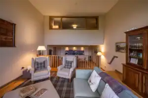 Interior view of a Highland Club Scotland living room with comfortable seating and traditional decor.