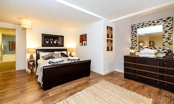 Elegant bedroom interior with modern decor and stylish furniture at Highland Club Scotland.