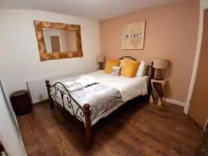 Modern bedroom with elegant decor and warm lighting in Highland Club Scotland development.