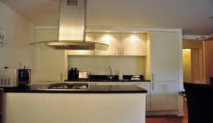 Modern kitchen with built-in appliances, sleek design, and Scottish Highlands views.