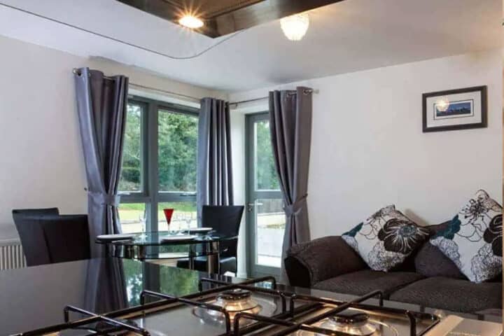 Modern living space with large windows and elegant curtains at Abbey Church 1.