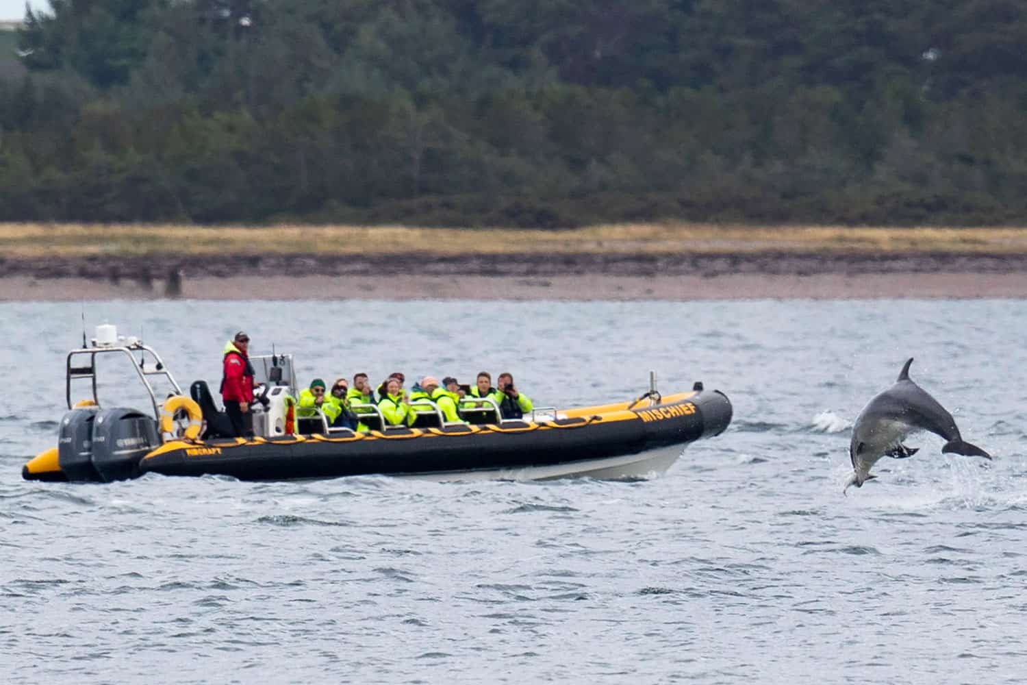 Highland Club Scotland development with a boat and dolphin in the water.