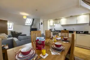 Bright Highland Club Scotland apartment with open-plan kitchen and dining area.