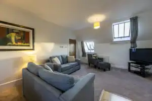 Bright and spacious living room with comfortable sofas and stylish decor at Highland Club Scotland.