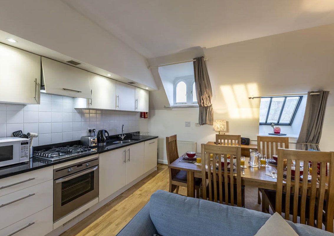 Bright Highland apartment kitchen with dining table and scenic window views.