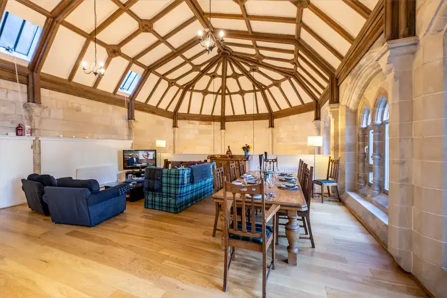 Historic Highland Club lounge with elegant wooden ceiling and cozy seating area.