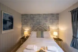 Elegant Highland Club Scotland bedroom with stylish decor and cosy lighting.