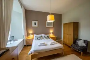 Comfortable bedroom at Highland Club with modern decor and natural light.