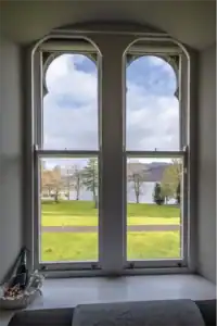 Beautiful lake and garden view from Highland Club apartment window in Scotland.