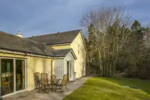 Beautiful Highland Club Scotland property with outdoor patio and lush garden.