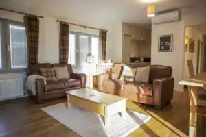 Spacious Highland Club living area with comfortable sofas and natural light.