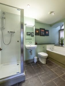 Bathroom with shower, toilet, and bathtub in Highland Club Scotland development.