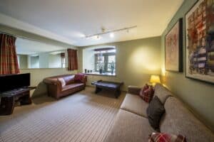 Highland Club Scotland lounge with cozy sofas and contemporary art on the walls.