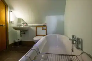 Accessible bathroom with bathtub and sink at Highland Club Scotland.