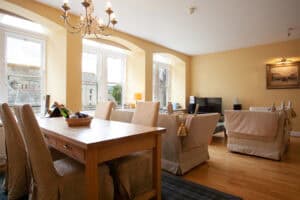 Bright Highland Club living room with large windows and comfortable seating.