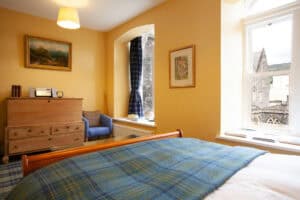 Comfortable bedroom at Highland Club with classic decor and scenic views.