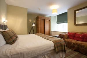Comfortable Highland Club bedroom with traditional decor and natural light.