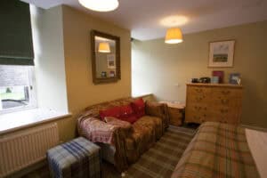Cozy Highland Club living area with traditional furnishings and warm lighting.