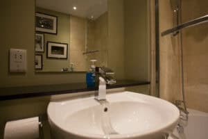 Bathroom with contemporary fixtures and elegant decor at Highland Club Scotland.