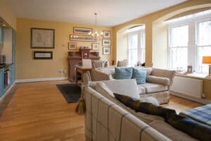 Bright and spacious living room with large windows and comfortable seating at Highland Club Scotland.