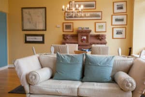 Elegant Highland Club living room with vintage decor, chandelier, and comfortable seating area.