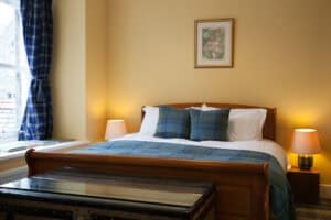 Comfortable Highland Club Scotland bedroom with classic decor and cozy ambiance.