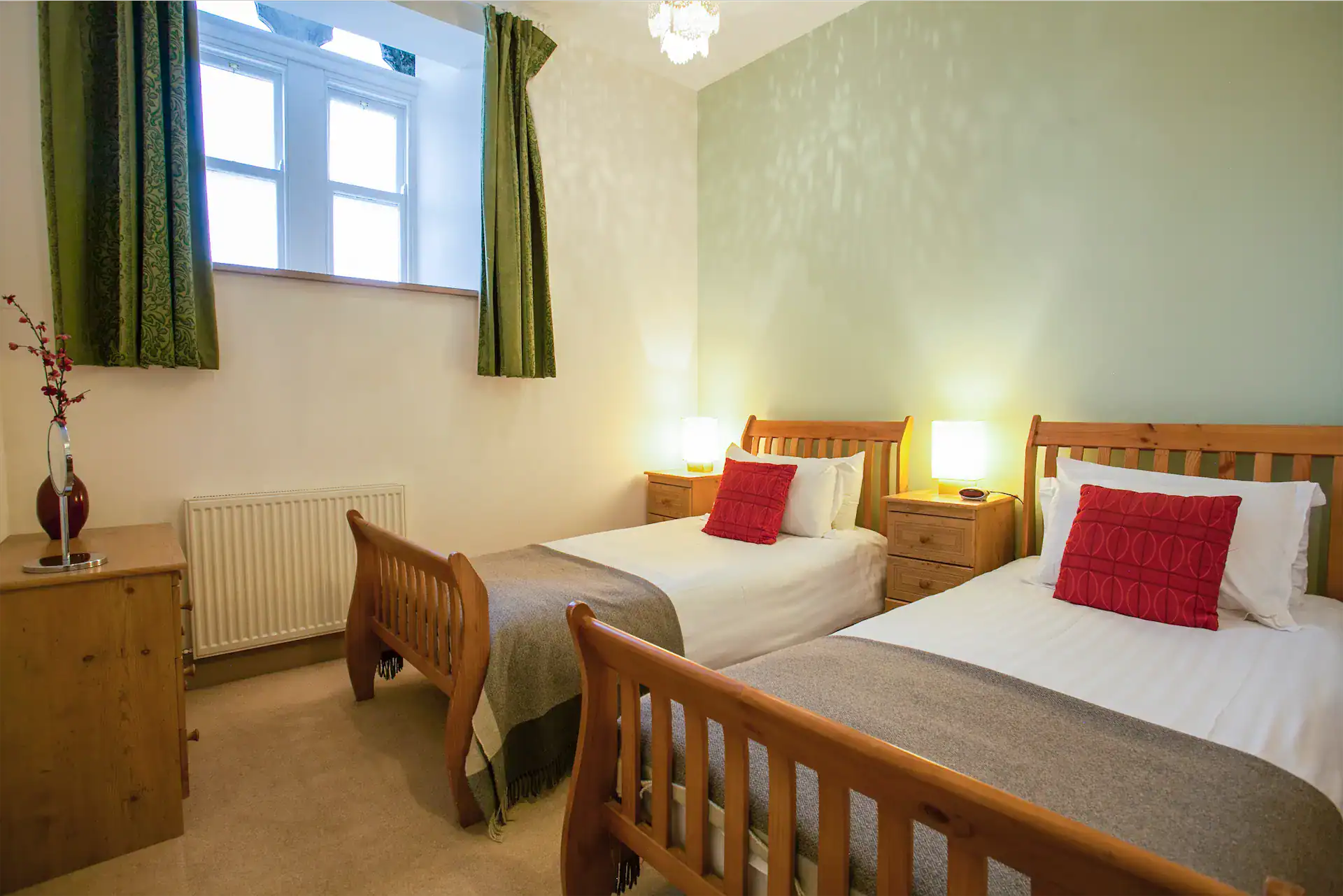 Comfortable twin bedroom with wooden beds and soft bedding at Highland Club Scotland.