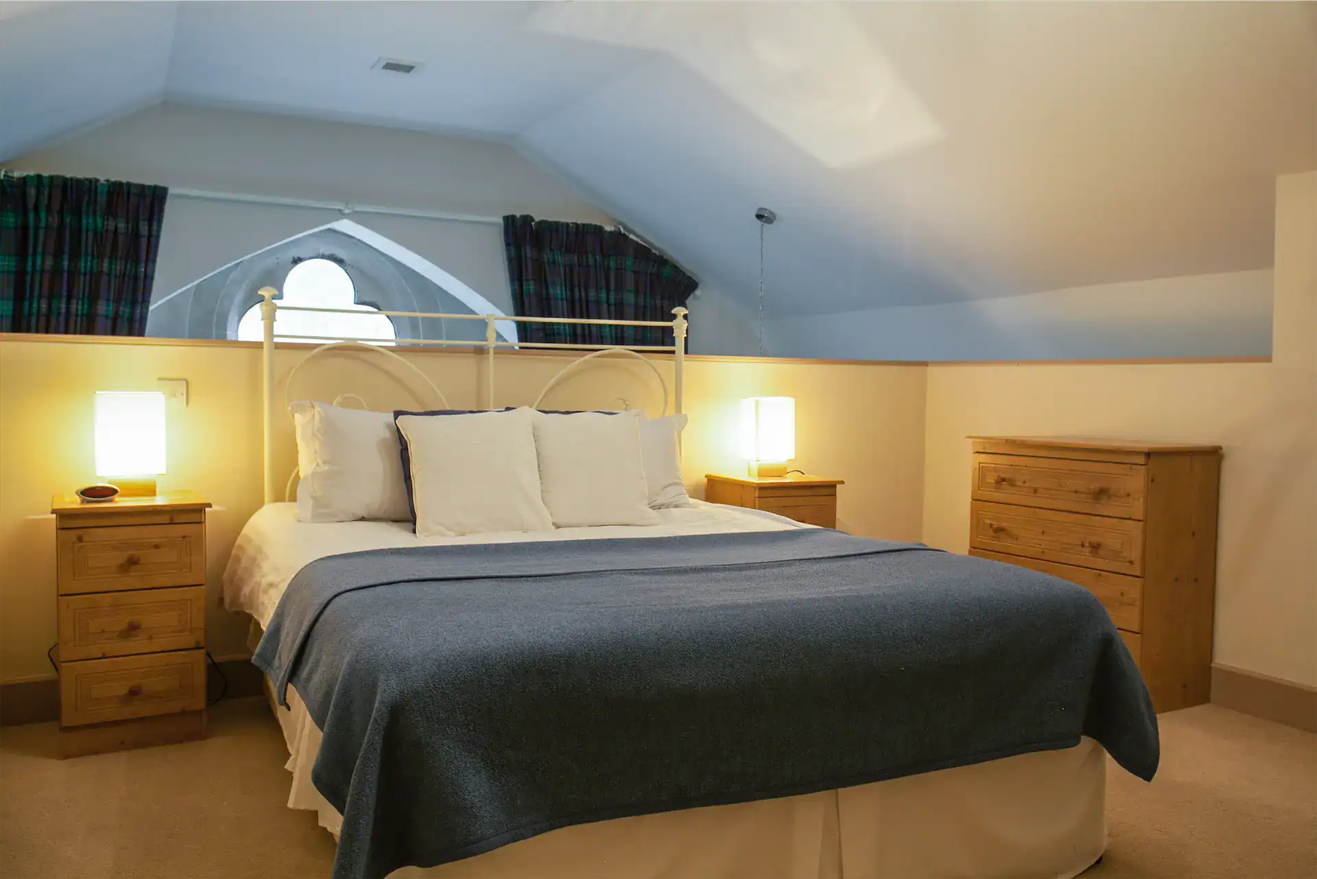 Elegant bedroom with comfortable bed and wooden furniture at Highland Club Scotland.
