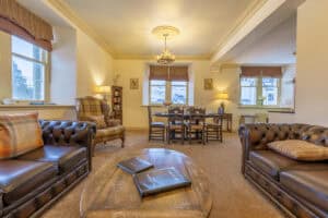 Elegant Highland living room with traditional furniture and large windows.