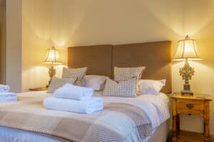 Cozy Highland Club Scotland bedroom with elegant decor and soft lighting.