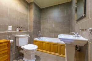 Bathroom with bathtub and sink in Highland Club Scotland development.