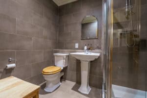 Modern bathroom with shower, toilet, and sink at Highland Club Scotland.