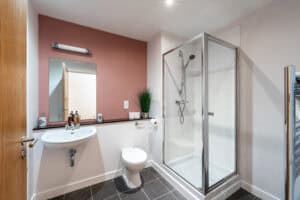 Bathroom with shower, toilet, and sink in Highland Club Scotland development.