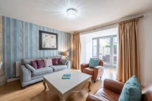 Highland Club Scotland living room with stylish furniture and natural light.