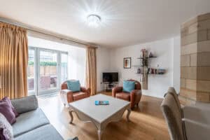 Highland Club Scotland living room with comfortable seating and natural light.