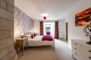 Elegant Highland Club Scotland bedroom with modern decor and scenic views.