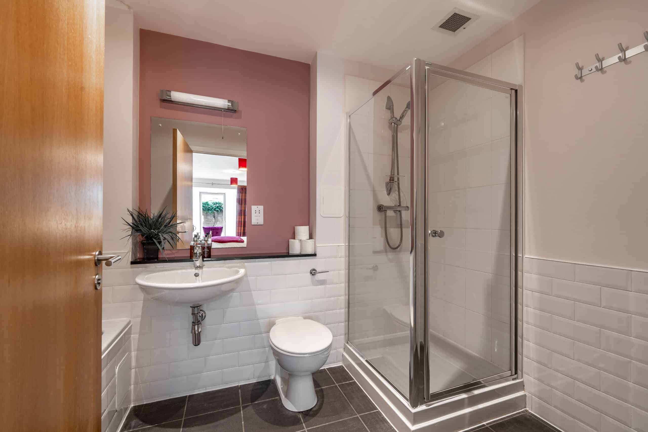 Bathroom with shower, toilet, and sink at Highland Club Scotland residential development.